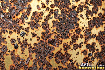 Layered rust surface of orange, brown and black flakes
