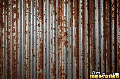 Heavily rusted steel plate with flaking orange scale and dark pits