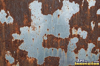 Rust bubbling up under old paint with blisters bursting open