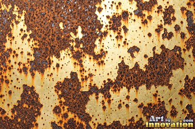 Layered rust surface of orange, brown and black flakes