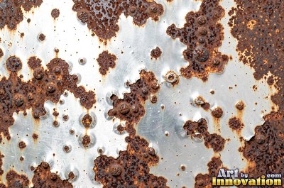 Heavily rusted steel plate with flaking orange scale and dark pits