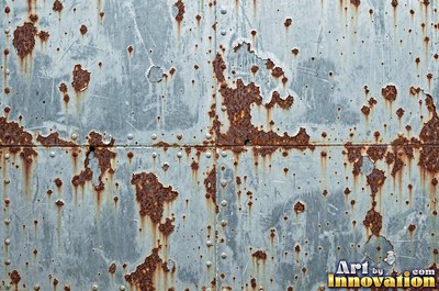 Rust bubbling up under old paint with blisters bursting open