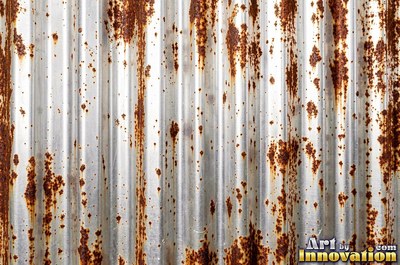 Layered rust surface of orange, brown and black flakes