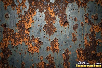 Corroded iron with streaks of rust running down from bolt holes
