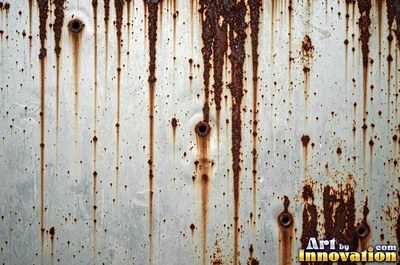 Heavily rusted steel plate with flaking orange scale and dark pits