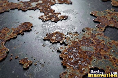 Layered rust surface of orange, brown and black flakes