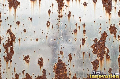 Heavily rusted steel plate with flaking orange scale and dark pits