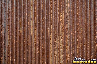 Corroded iron with streaks of rust running down from bolt holes