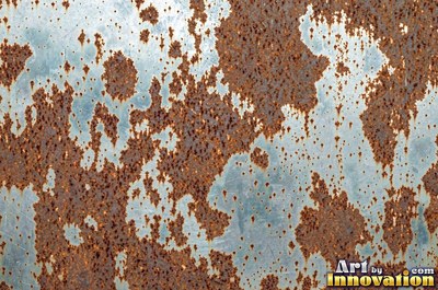 Layered rust surface of orange, brown and black flakes