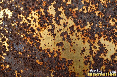 Rust bubbling up under old paint with blisters bursting open