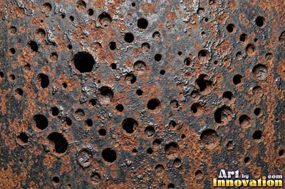 Rust bubbling up under old paint with blisters bursting open