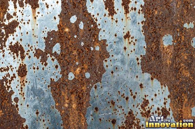 Corroded iron with streaks of rust running down from bolt holes