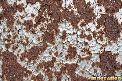 Layered rust surface of orange, brown and black flakes