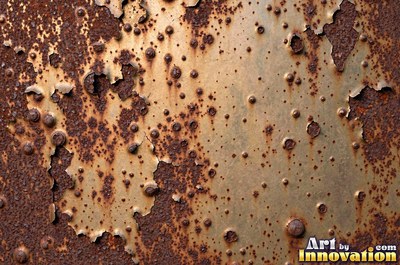 Rust bubbling up under old paint with blisters bursting open