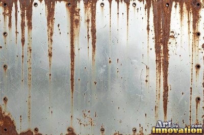 Corroded iron with streaks of rust running down from bolt holes