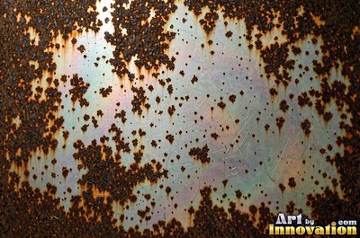 Layered rust surface of orange, brown and black flakes