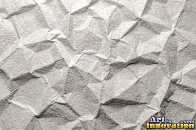 Folded paper in a regular geometric crease pattern