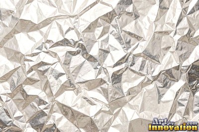 Crumpled paper smoothed out with a web of sharp creases in aged ivory