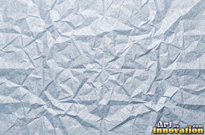 Folded paper in a regular geometric crease pattern