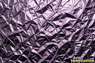 Crumpled foil paper catching bright highlights in pale blue