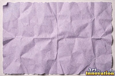 Crumpled paper smoothed out with a web of sharp creases in aged ivory