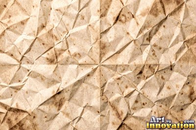 Folded paper in a regular geometric crease pattern