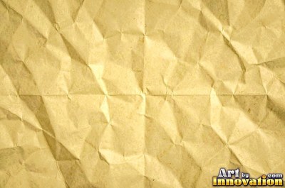 Crumpled foil paper catching bright highlights in pale blue