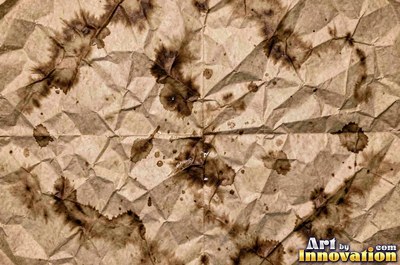 Crumpled paper smoothed out with a web of sharp creases in aged ivory