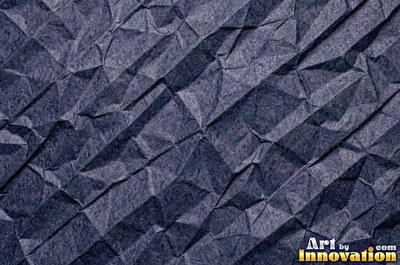 Folded paper in a regular geometric crease pattern