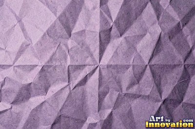 Folded paper in a regular geometric crease pattern
