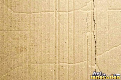 Crushed charcoal black cardboard with dents and folds