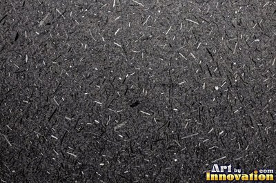 Crushed charcoal black cardboard with dents and folds