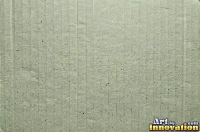 Torn kraft brown cardboard revealing the corrugation underneath