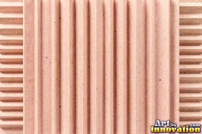Torn kraft brown cardboard revealing the corrugation underneath