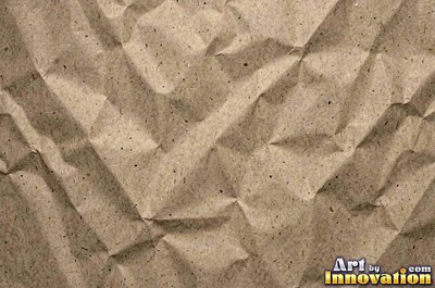 Crushed charcoal black cardboard with dents and folds