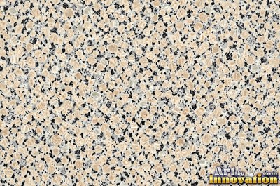 Polished granite with dense speckles of mineral crystals in warm beige