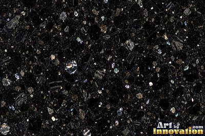 Green gray polished granite with a few large dark crystal clusters