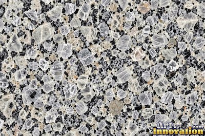 Polished granite with dense speckles of mineral crystals in warm beige