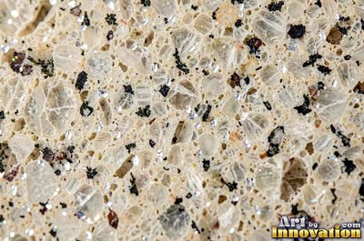 Polished granite with dense speckles of mineral crystals in warm beige