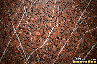 Polished granite with dense speckles of mineral crystals in warm beige