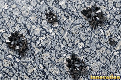 Polished granite with dense speckles of mineral crystals in warm beige