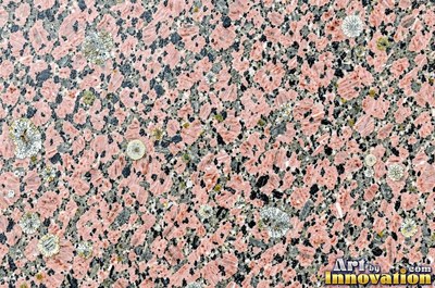 Green gray polished granite with a few large dark crystal clusters