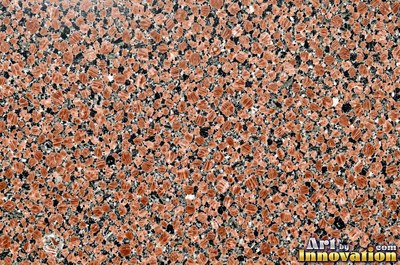 Polished granite with dense speckles of mineral crystals in warm beige