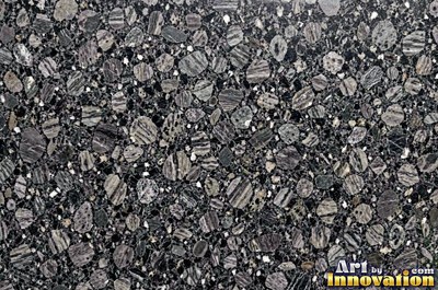Green gray polished granite with a few large dark crystal clusters