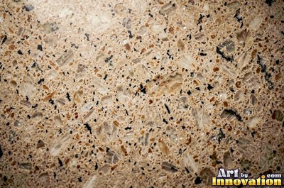 Polished granite with dense speckles of mineral crystals in warm beige