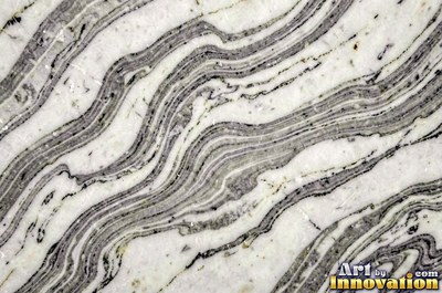 Bold dramatic marble veining in thick sweeping bands of ivory and gold