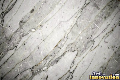 Bold dramatic marble veining in thick sweeping bands of ivory and gold
