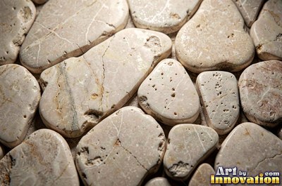 Flat skimming stones overlapping like scales in warm beige