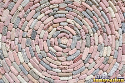 Smooth river pebbles packed tightly in salt and pepper tones
