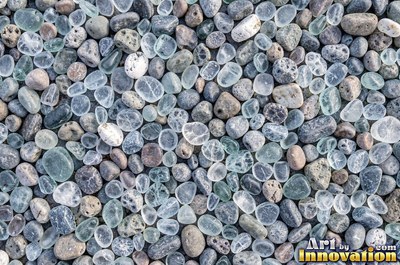 Smooth river pebbles packed tightly in salt and pepper tones